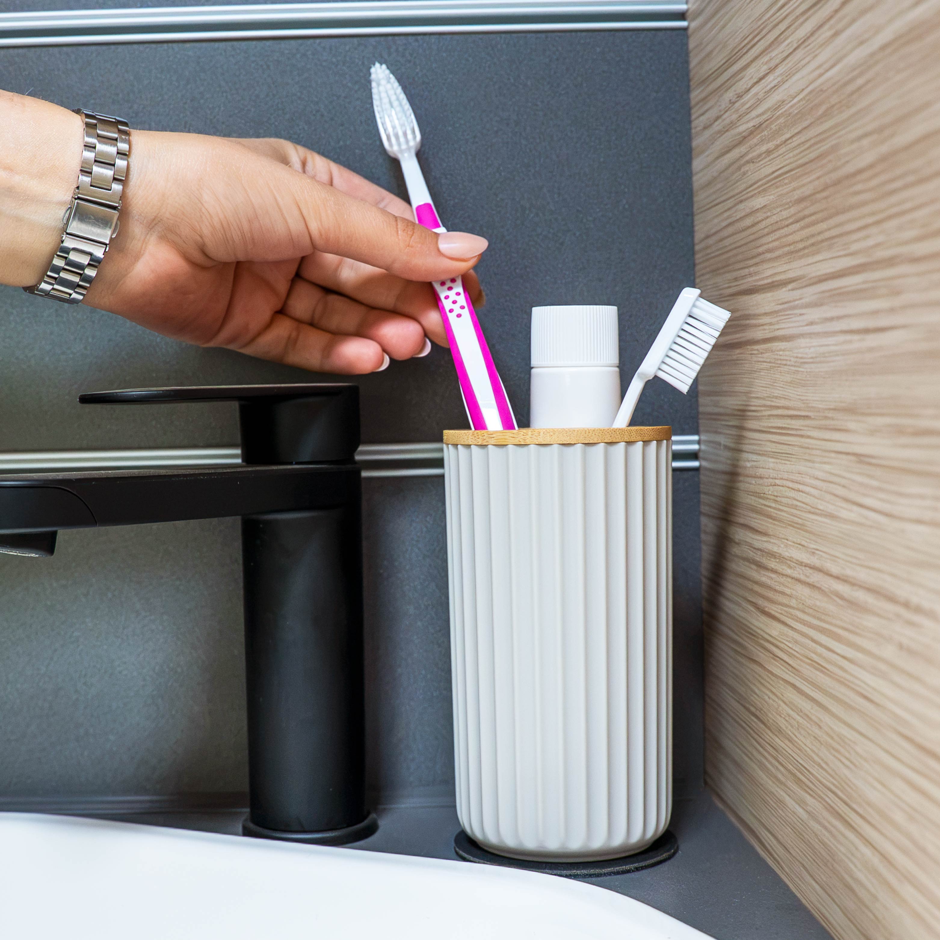 Magnetic soap dispenser and magnetic toothbrush cup including pads