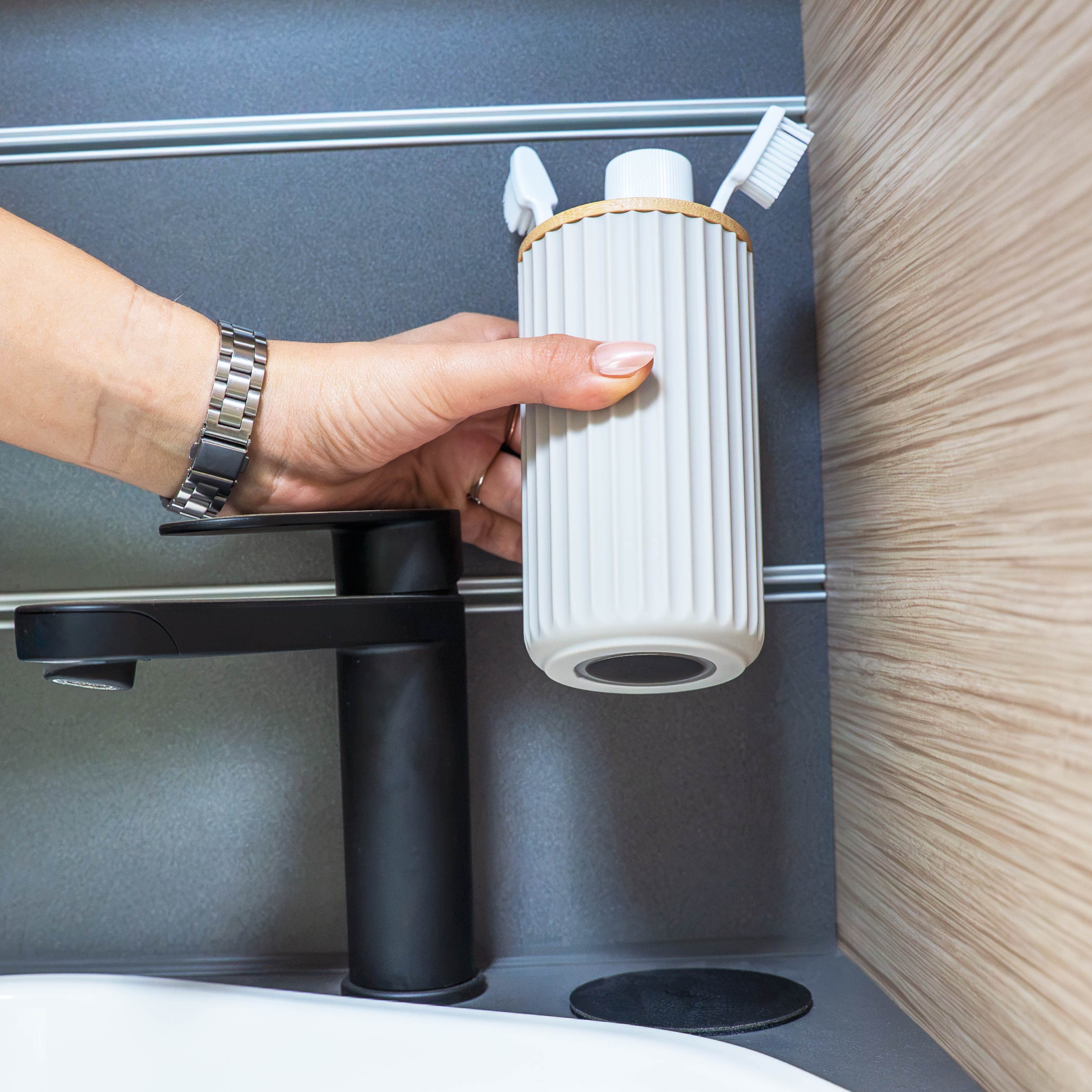 Magnetic soap dispenser and magnetic toothbrush cup including pads