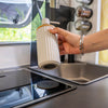 Magnetic soap dispenser and magnetic toothbrush cup including pads
