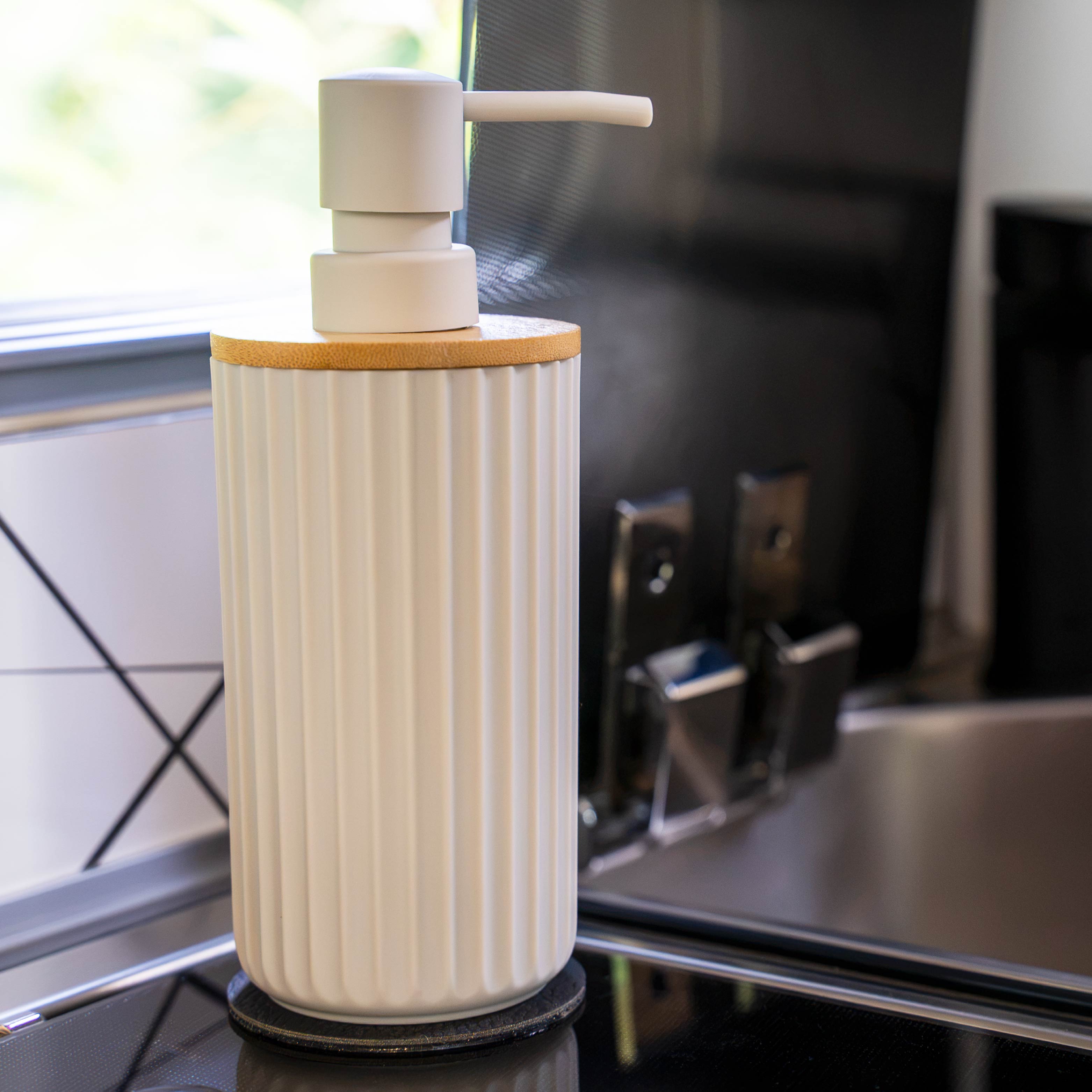 Magnetic soap dispenser and magnetic toothbrush cup including pads